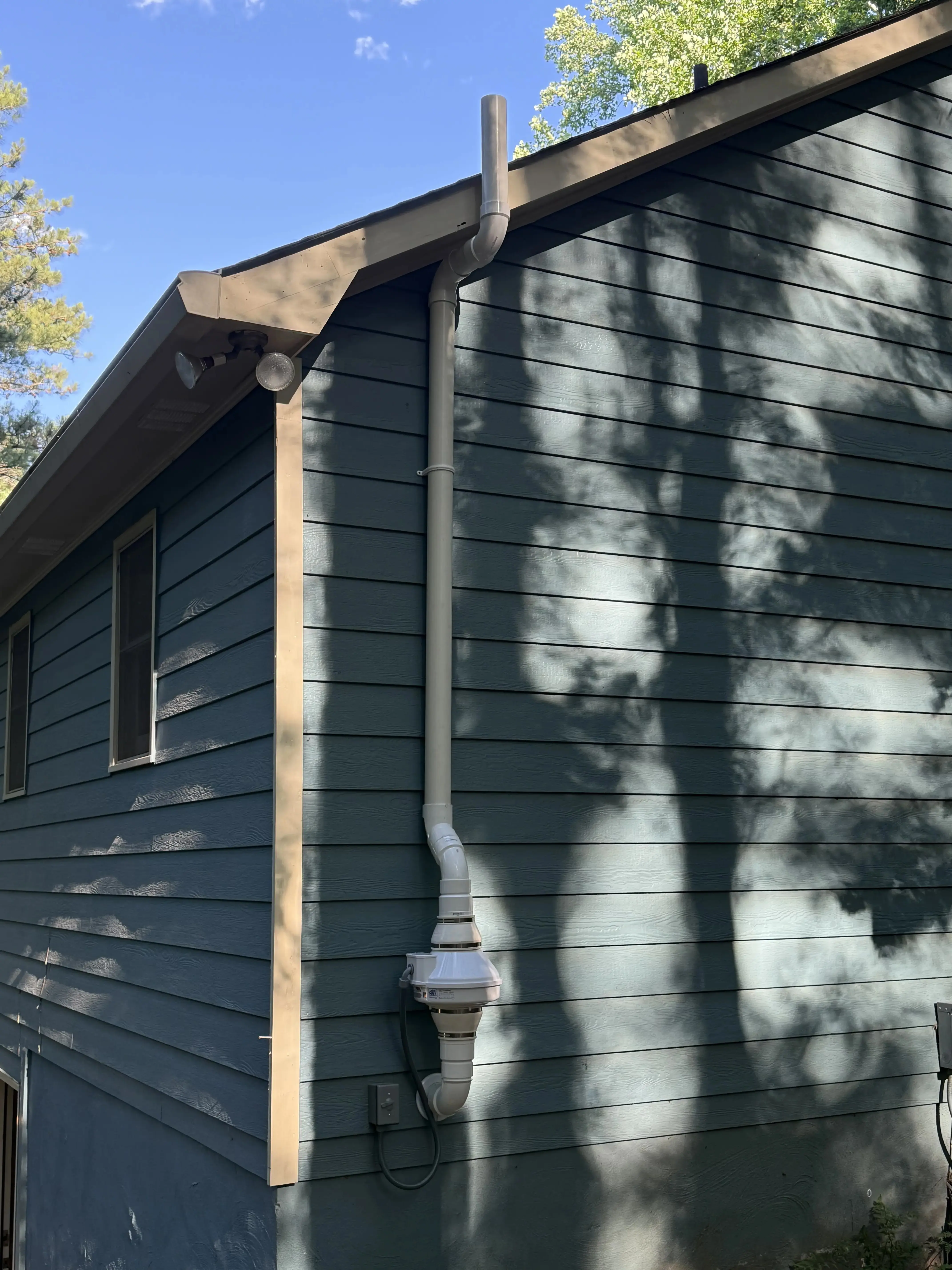 radon mitigation installation on exterior of home